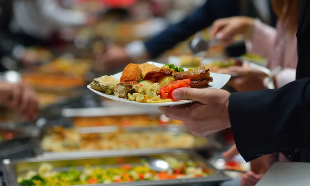 A plate of assorted buffet food held by a hand at CHINA BUFFET, a Buffet Restaurant in Jacksonville